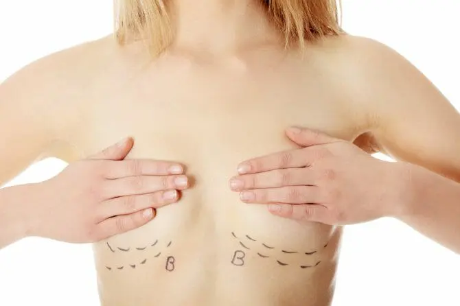 woman covering her breasts with her hands